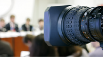 Camera pointed at board members during a meeting